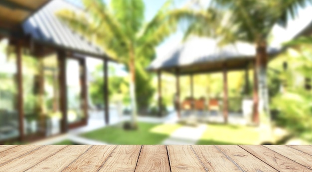 Photo empty wooden table with blurred modern garden on background