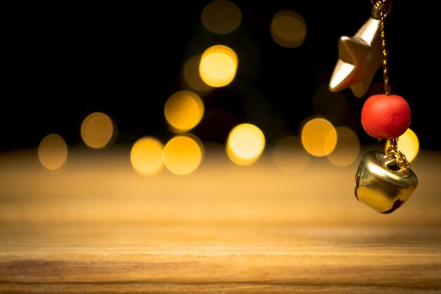 Empty wooden table with christmas lights, golden sparkles and bokeh. Holiday and new year background, free space for your design or products