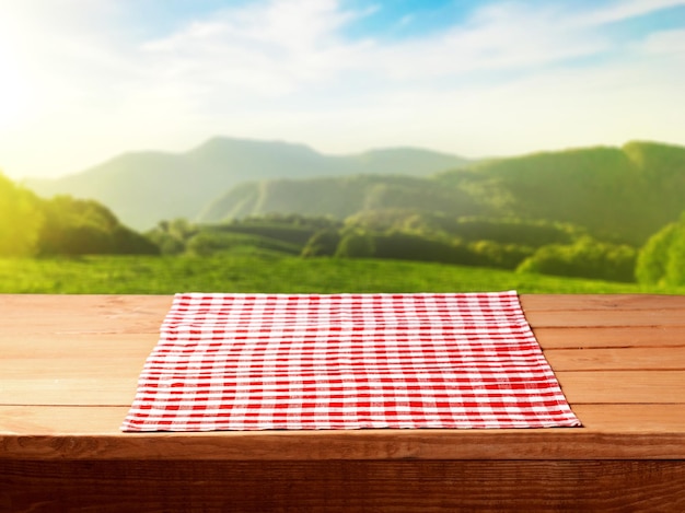 Empty wooden table with red tablecloth