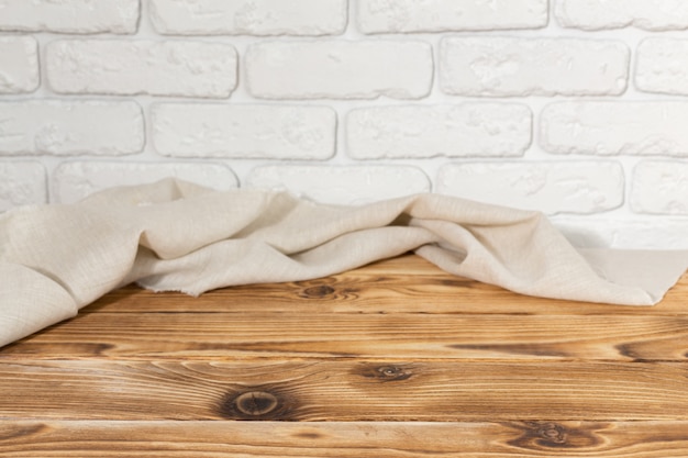 empty wooden table with tablecloth