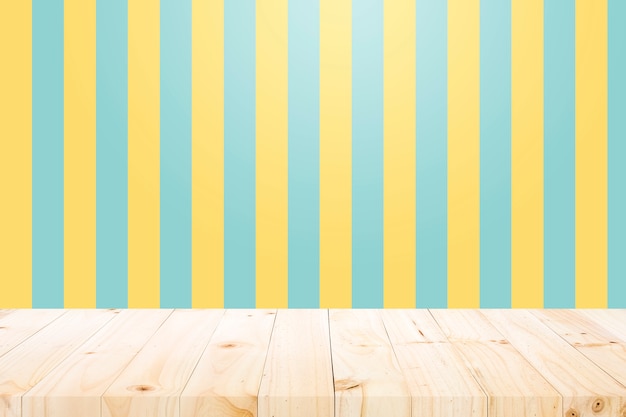 Photo empty wooden table over yellow and aqua background.