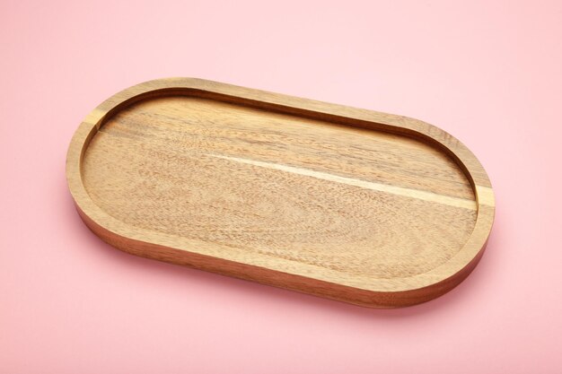 Empty wooden tray on pink background Rectangular wooden dish Top view