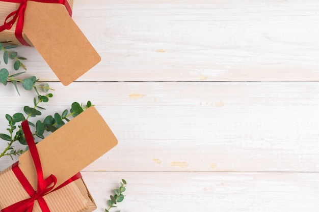 Empty xmas wish list with little gift  on wooden table