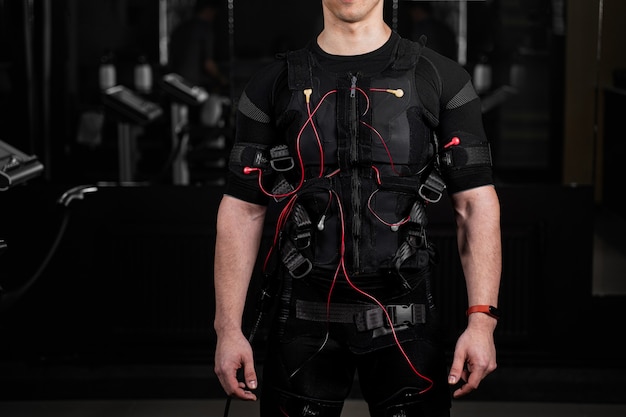 EMS suit with red wires for electro impulse stimulation for body