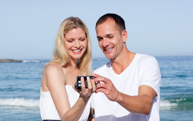 Enamored couple looking at holiday photograph 