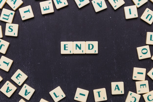 End scrabble letters arranged over black backdrop