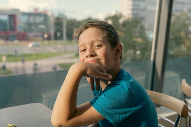 Endearing Image of a Charming Caucasian Boy Seated at a Table