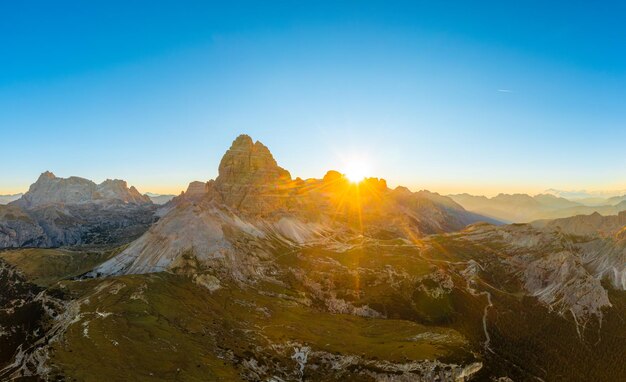 Endless rocky mountain ranges with hilly valleys in alps at sunrise majestic landscape of three