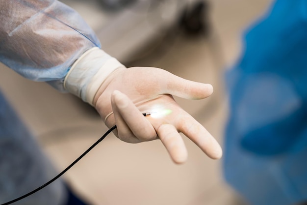 Endoscopic examination conducted in the hospital. Selective focus on doctor`s hands. Closeup.