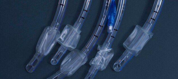 endotracheal tubes of different diameters lie on a dark background. close-up