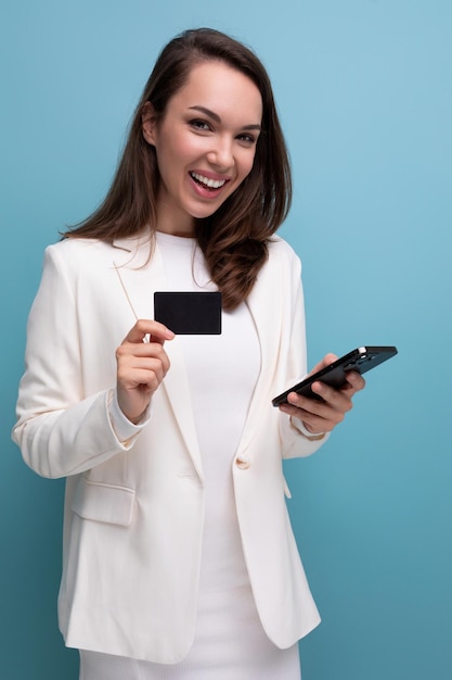 Energetic brunette woman in office dress with shopping card