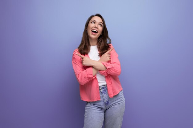 Energetic happy young woman in long summer look on studio isolated background