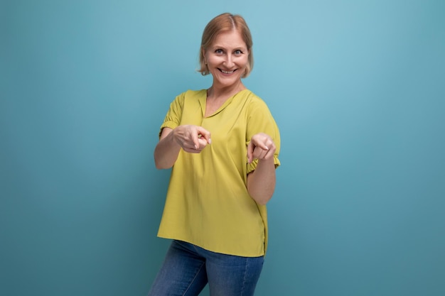 Energetic mature woman pointing finger at camera