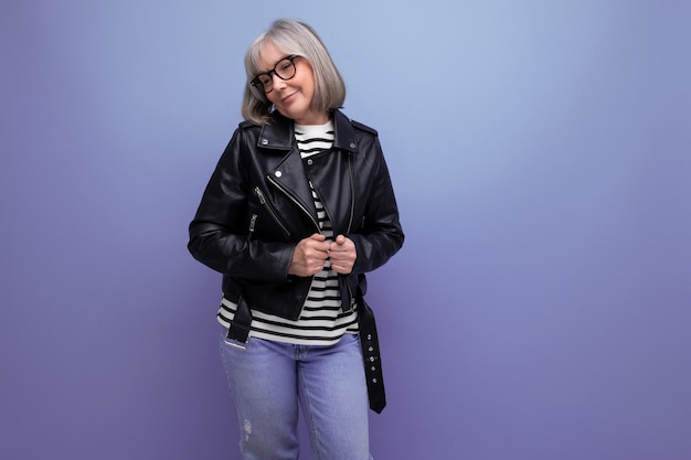 Energetic mature woman in a stylish jacket on a bright background