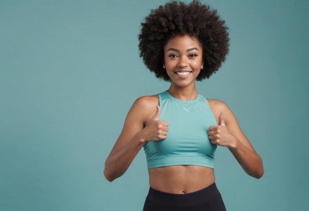 Photo an energetic woman with an afro gives two thumbs up her lively expression and fitness attire shine