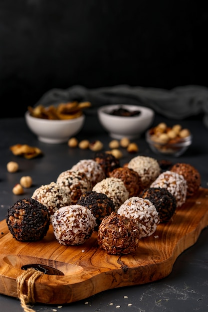 Energy balls of nuts, oatmeals and dried fruit on dark background