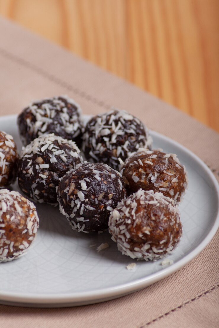 Energy balls on a plate on a wooden table