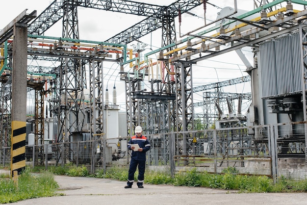 The energy engineer inspects the equipment of the substation. Power engineering. Industry.