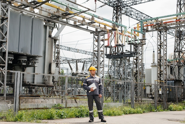 The energy engineer inspects the equipment of the substation. Power engineering. Industry. 