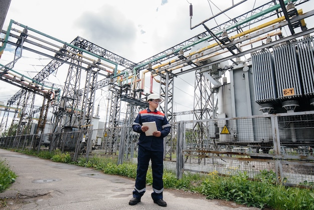 The energy engineer inspects the equipment of the substation. Power engineering. Industry.