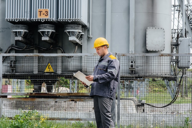 The energy engineer inspects the equipment of the substation. Power engineering. Industry.