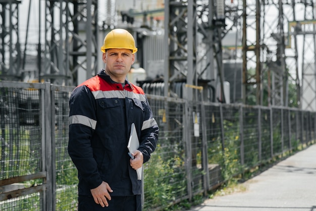 The energy engineer inspects the equipment of the substation. Power engineering. Industry.