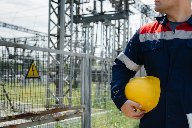 The energy engineer inspects the equipment of the substation. Power engineering. Industry.