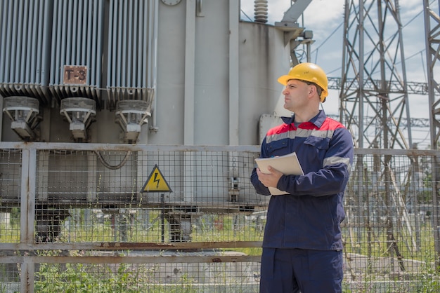 Foto l'ingegnere energetico ispeziona l'attrezzatura della sottostazione. ingegneria energetica. industria.