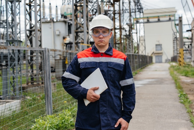 The energy engineer inspects the equipment of the substation