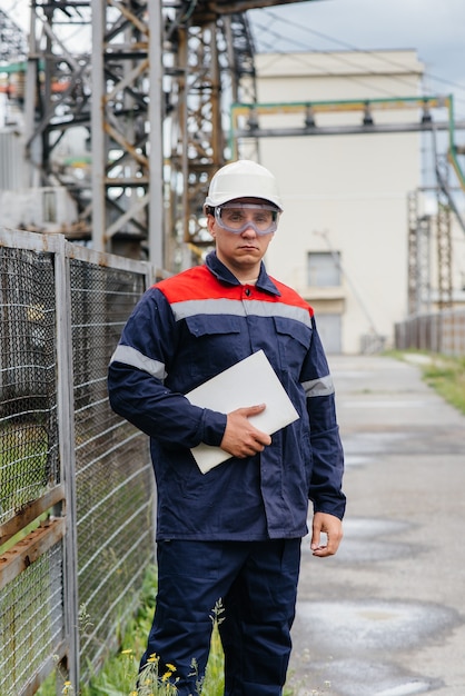 Energy engineer inspects the equipment of the substation