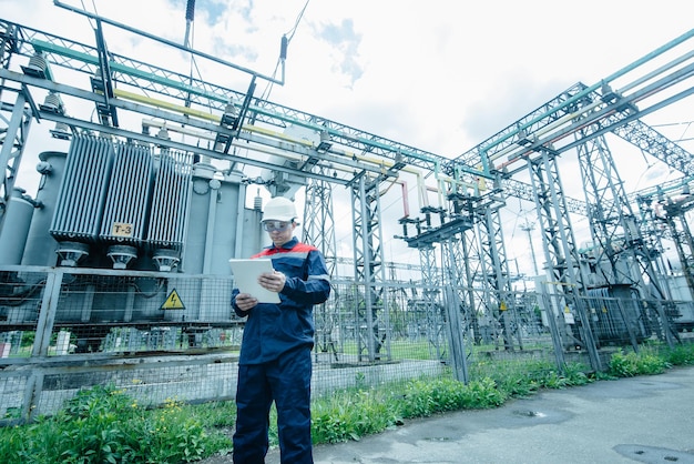 An energy engineer inspects the modern equipment of an electrical substation before commissioning Energy and industry Scheduled repair of electrical equipment