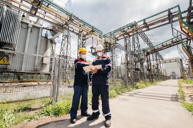 The energy engineers inspect the equipment of the substation