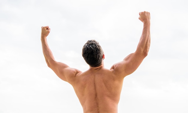 Energy inside. Bodybuilder showing muscles. muscular back man isolated on white. torso and back training sport. sport success. celebrating success. welcome new startup. We did it.