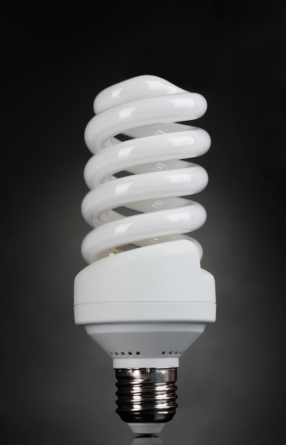 Energy saving light bulb on gray background