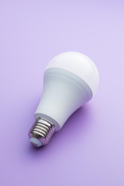 Energy saving light bulb on violet background LED light bulb