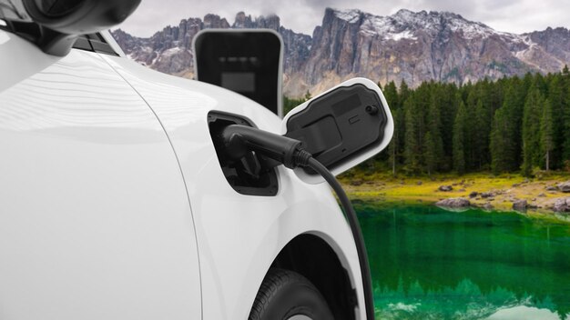 Foto energia sostenibile auto potenza da generatore elettrico guida ricarica batteria alla stazione di ricarica con sfondo di montagna per il concetto di viaggio progressivo ev auto in natura come simbolo per l'ambiente pulito