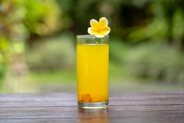 Energy tonic drink with turmeric, ginger, lemon and honey in glass