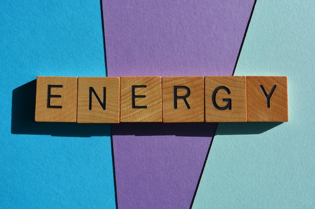 Energy word in wooden alphabet letters isolated on blue and purple background