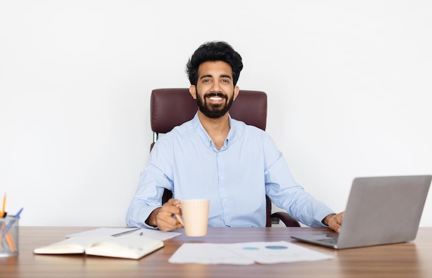 Engaged indian businessman in a white office