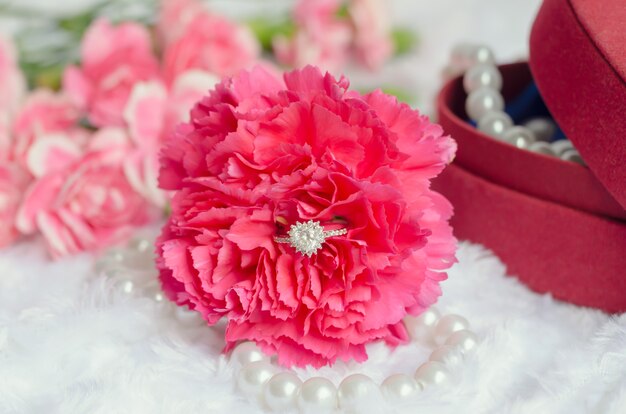 Engagement diamond ring in pink carnation flower