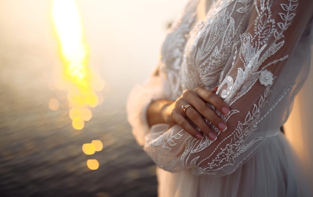 Engagement ring on bride's finger Beautiful bride in a white dress with an elegant wedding ring