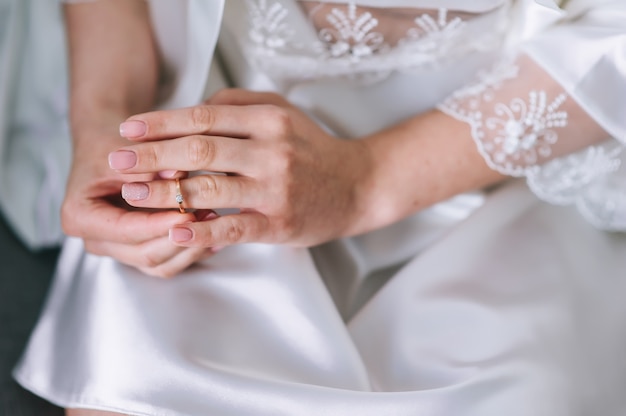 Engagement ring on bride's finger. Wedding day.