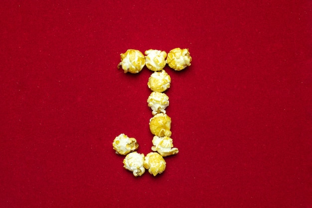 Engels alfabet van bioscoop popcorn achtergrond, letter J