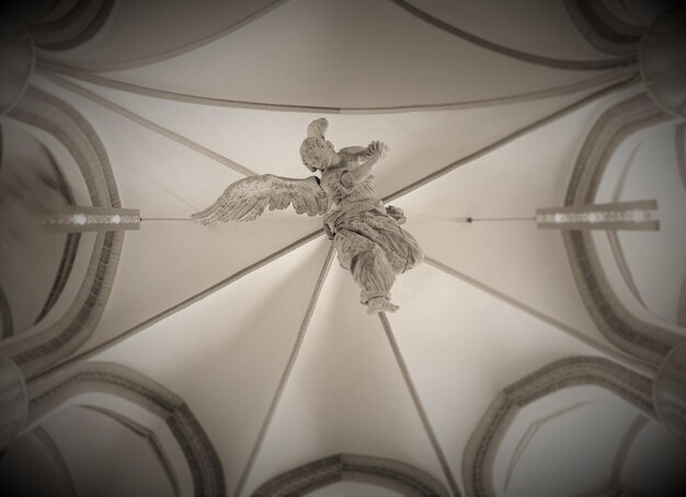 Foto engelsculptuur tegen het plafond van de kerk