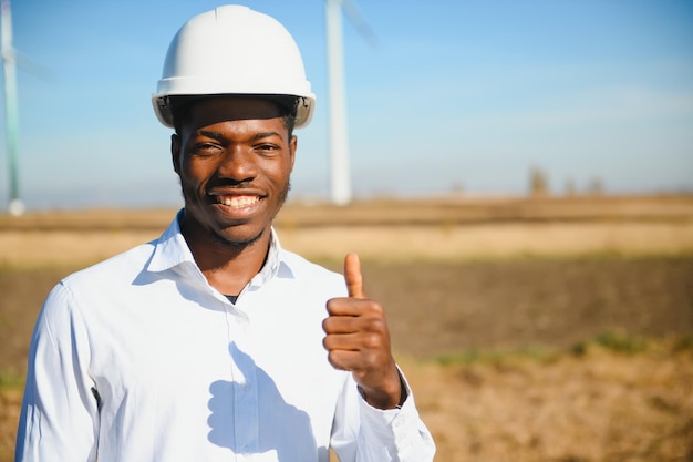 Engineer African man standing with wind turbine