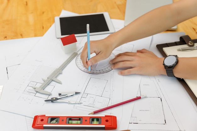 Engineer and Architect concept, Engineer Architects  and Interior designer working with blueprints