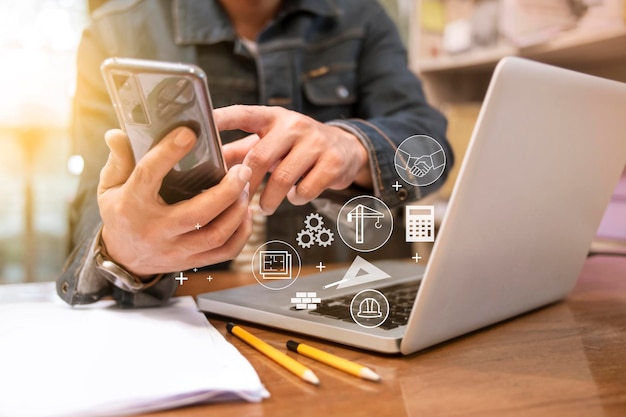 Photo engineer or architect uses smartphones to meeting with suppliers to plan construction