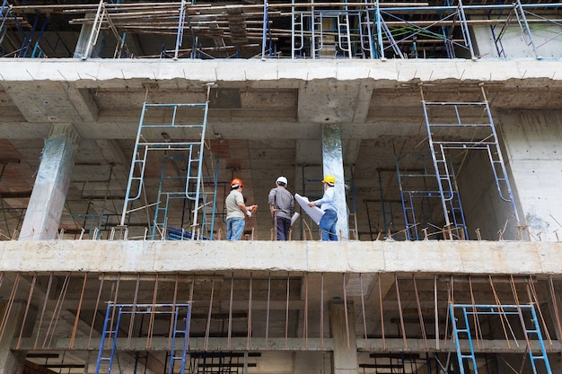 Engineer and Architect working at Construction Site