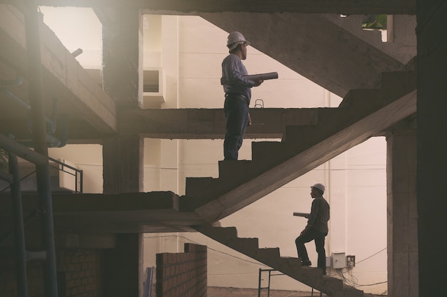 Engineer and Architect working at Construction Site.