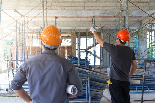 Photo engineer and architect working at construction site.